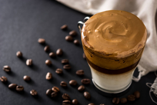 Creamy iced dalgona coffee on black background. Copy space - Photo, Image