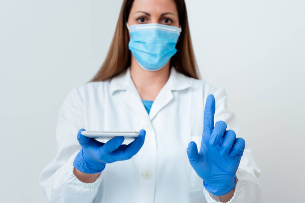 Person, die medizinisches Kleid Handschuhe Chirurgische Maske Verschiedene Winkel Aufnahmen mit leerem Aufkleber Papier Zubehör Modernes Smartphone - Foto, Bild