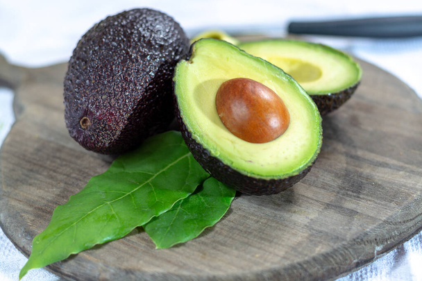 Two fresh ripe raw hass avocados, close up, healthy food concept - Photo, Image