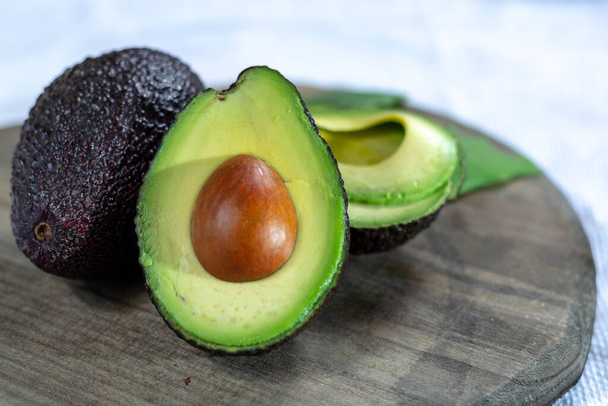 Two fresh ripe raw hass avocados, close up, healthy food concept - Photo, Image