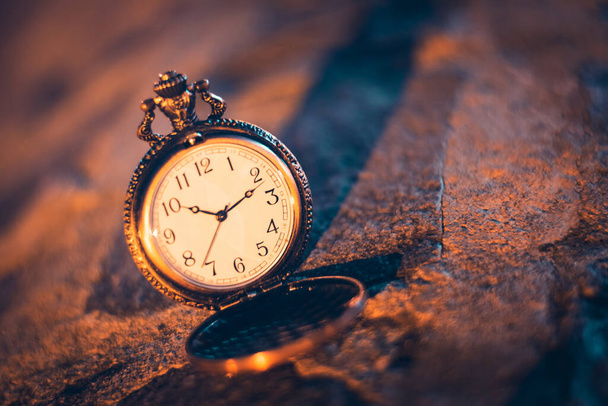 An old pocket watch photographed close to the blurred background - Photo, Image