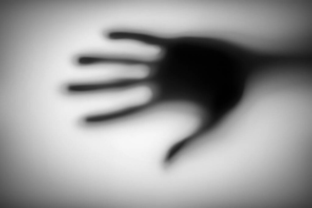 blurred of a hand behind matted glass. - Photo, Image