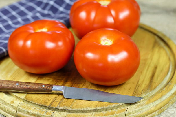 tomato on a wooden board - 写真・画像