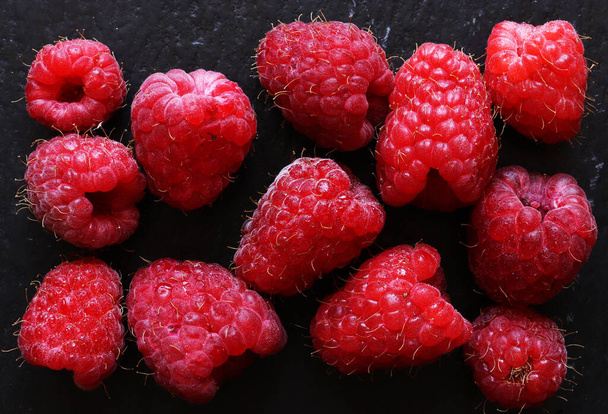 Photography of a handful of raspberries on slate for food illustrations - Photo, Image