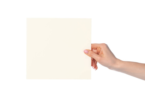 Womans hand showing white paper banner isolated on white - Zdjęcie, obraz