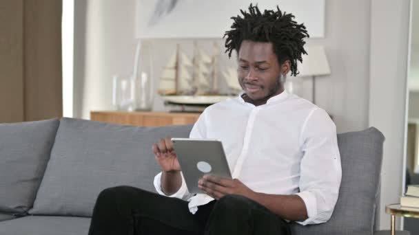 Young African Man using Digital Tablet in Home  - Felvétel, videó