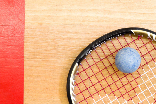 Close up of a squash racket and ball on the wooden background, sport concept - Photo, Image