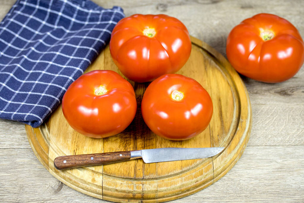tomato on a wooden board - 写真・画像