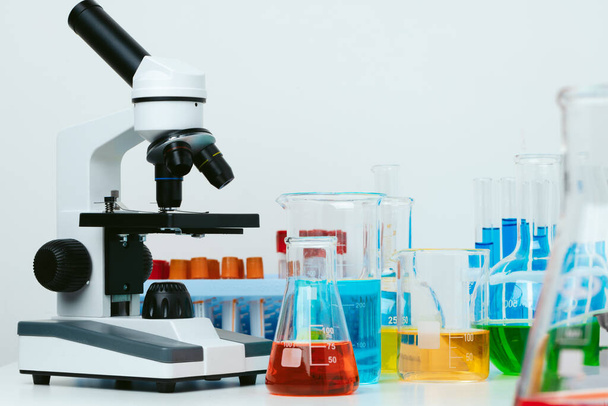 Scientific laboratory with microscope and test tubes with samples, close up photo - Foto, imagen