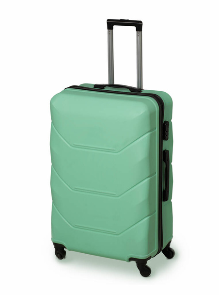 Mint Green suitcase for travel and reliable luggage storage. Plastic suitcase with wheels and retractable handle. Vacation concept. Luggage protection. Isolated on white background - Foto, afbeelding