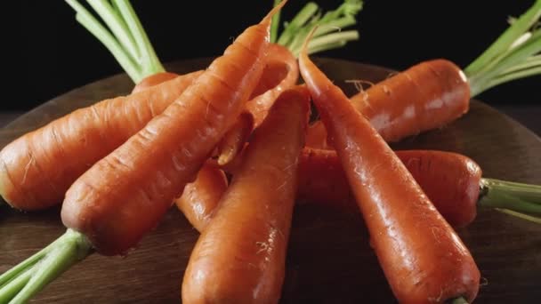 Fresh clean carrots close-up on a dark background - Footage, Video