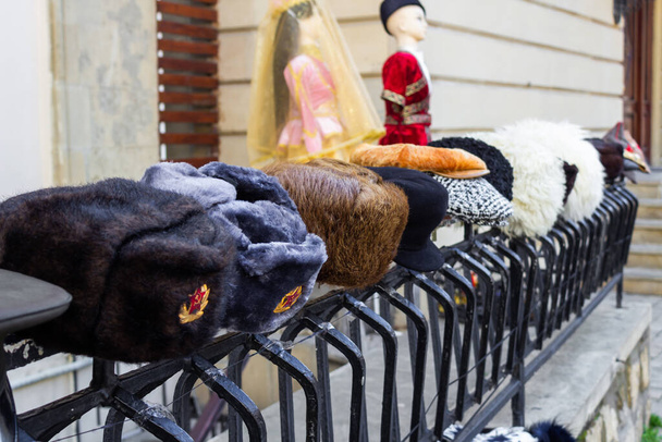 Hats of different nations and nationalities of all time are for sale in the old city - Photo, Image