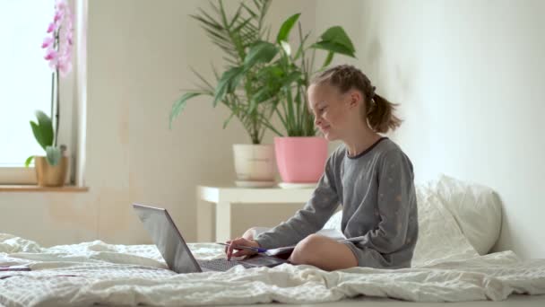 Cute child use laptop for education, online study, home studying. Girl have homework at home schooling. - Materiaali, video