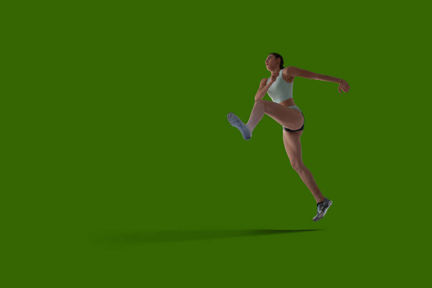 Athlete woman in sport clothes on green screen background. - Photo, Image