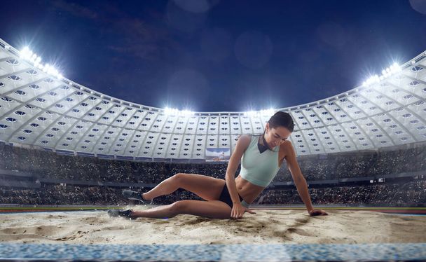 Female athlete on professional athletics stadium. - Photo, Image