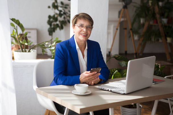 Attractive aged businesswoman working laptop computer indoors. - Foto, imagen