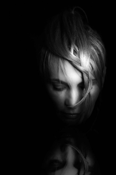 Portrait of a woman. Black and white studio shot. - Foto, afbeelding