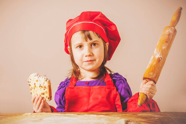 Young little chef girl preparing sweet desert at home kitchen. Nutrition and education concept - Photo, Image