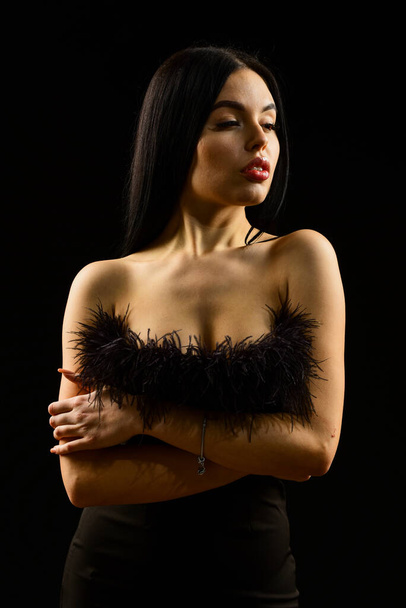 Glamorous style. Fashion concept. Elegance in simplicity. Black is perfect. Fancy clothes. Fashion shop. Feather decorations. Elegant woman fashion model. Fashionable girl wearing dress with feathers - Fotó, kép