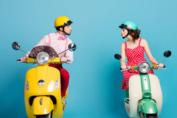 Profile side photo of romantic dreamy two people driver rider drive motor bike have honeymoon adventure send air kiss copyspace wear red skirt shirt isolated over blue color background - Photo, Image
