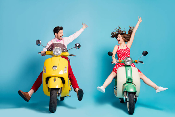 Portrait of his he her she nice attractive lovely cheerful cheery excited glad guys driving moped having fun fooling isolated over bright vivid shine vibrant blue color background - Fotografie, Obrázek