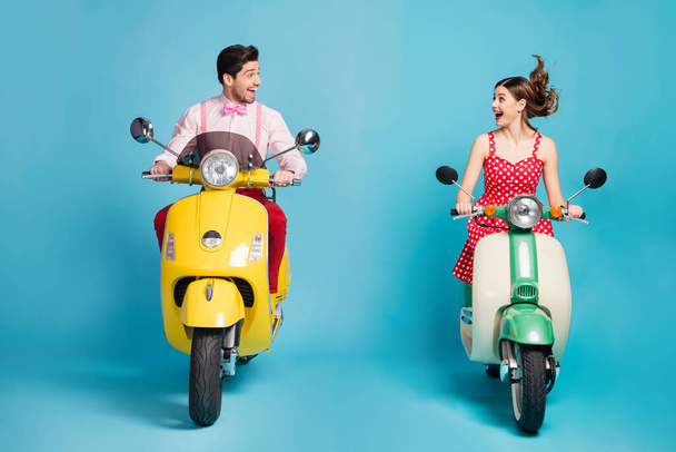 Photo of funky two people lady guy couple drive retro moped big speed travelers avoiding traffic jam easy way formalwear vintage clothes isolated blue color background - Фото, зображення
