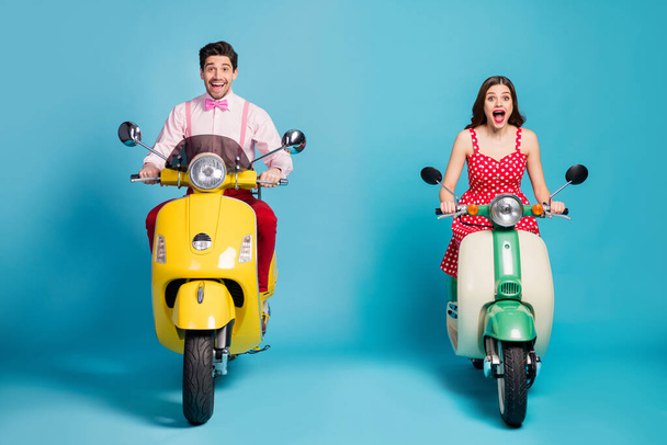 Full length photo of shocked wife husband motor bikers drivers ride electric scooter impressed scream wow omg wear red dotted skirt pink shirt isolated over blue color background - Фото, зображення