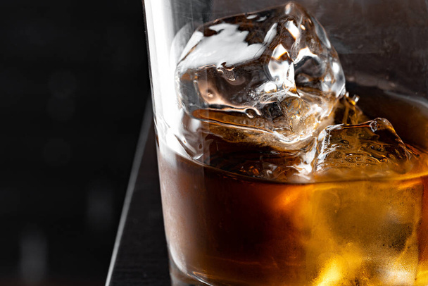 Whisky glass against dark black grunge wall - Φωτογραφία, εικόνα