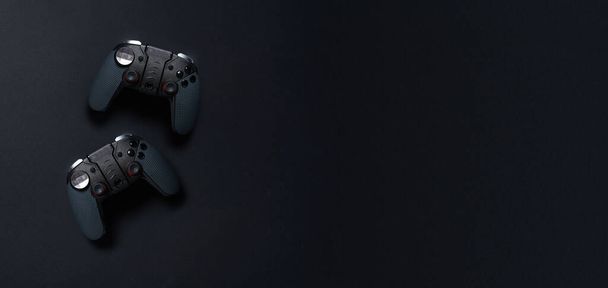 Black gamepads on black background. - Photo, Image