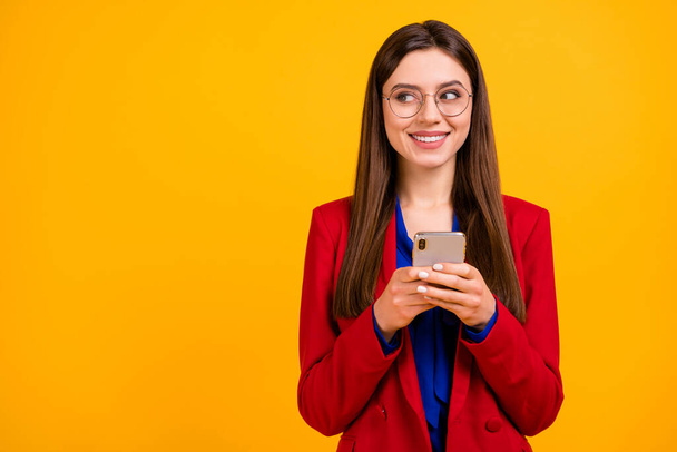 Portrait of positive business lady use cellphone look copyspace follow comment post social media news wear blazer isolated over bright shine color background - 写真・画像