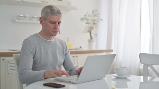 Senior Old Man Celebrating Success on Laptop at Home  - Video