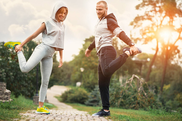 Urban sports - couple jogging for fitness in the city with beautiful nature. - Zdjęcie, obraz