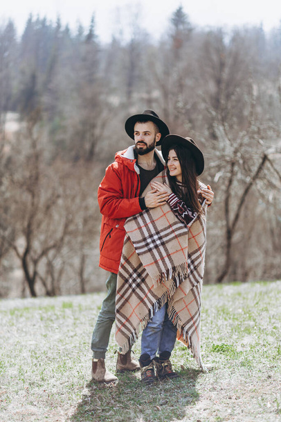Loving couple walking on the mountain outdoors. Man and woman travel together. Couple traveler enjoys nature, hugs, - Fotografie, Obrázek