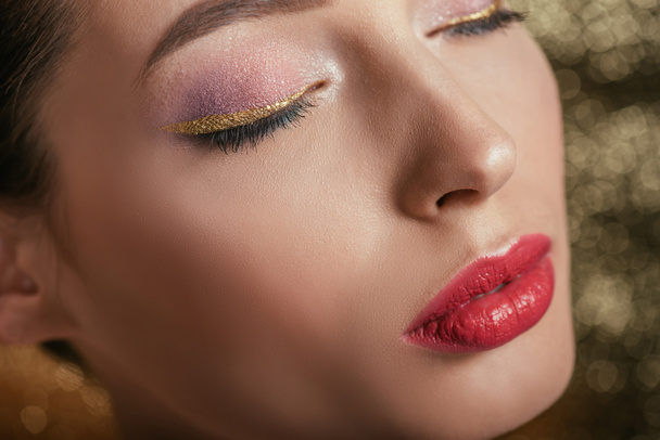 close up view of beautiful woman with shiny makeup and closed eyes - Фото, зображення