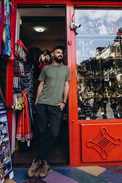 photo of stylish bearded tourist strolling through the streets of Tbilisi's old city, posing for photos, taking photos and talking with people - Foto, imagen