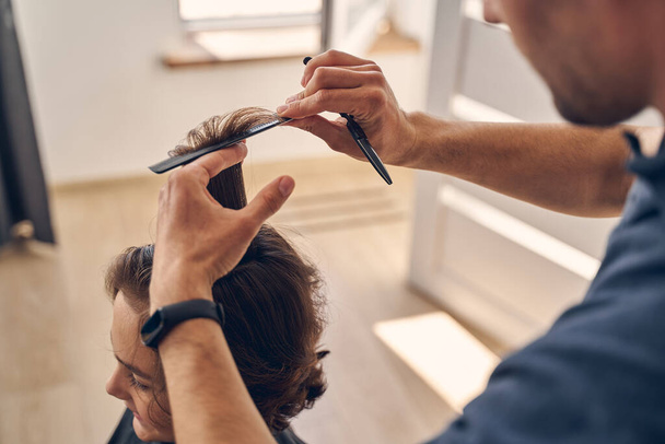 Process of cutting hair with special equipment - Фото, зображення