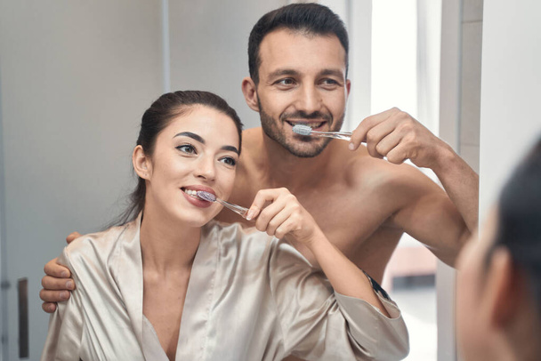 Cute married couple doing morning procedures in bathroom together - Foto, immagini