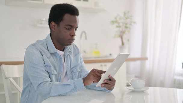African Man using Tablet at Home - Materiaali, video