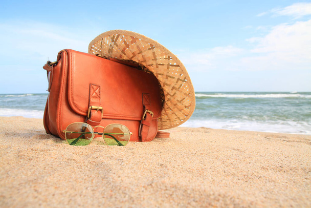relajación en la playa con gafas, sombreros, bolsas de vacaciones
  - Foto, Imagen