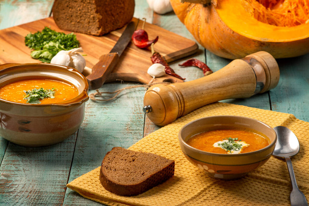 Вегетарианский суп с тыквенными сливками. Тыквенный суп со специями на деревянном столе
 - Фото, изображение