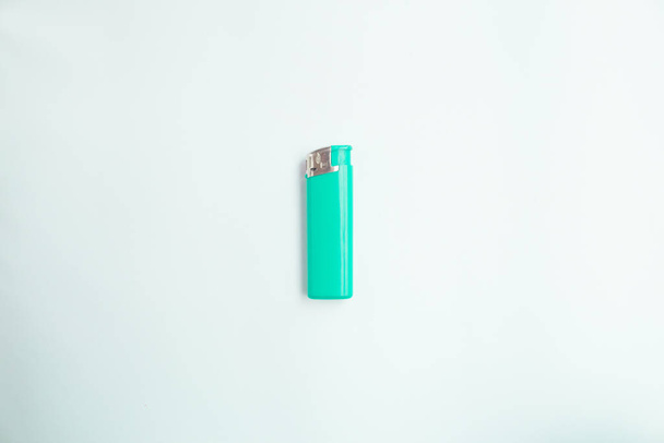  blue lighter with a button on a brown and white background. Top view. Mock up. Flat lay composition. - Фото, изображение
