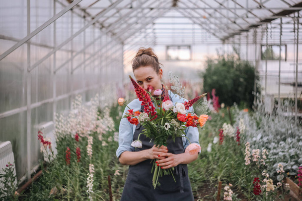 Girl with a bouquet of fresh cut flowers - Photo, Image