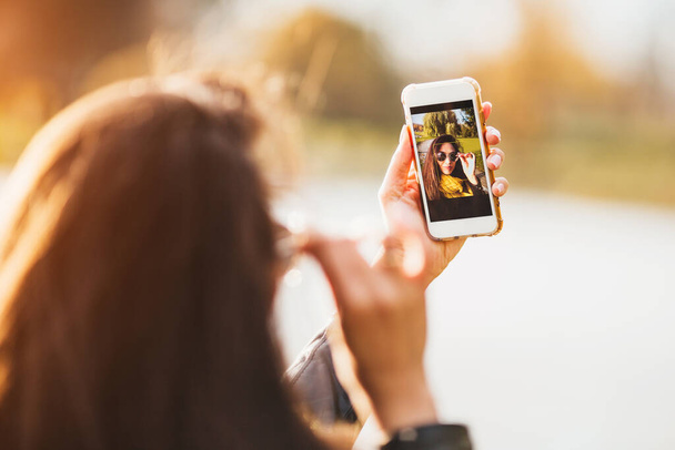 Focus on smartphone screen during selfie - attractive sexy brunette - Fotoğraf, Görsel