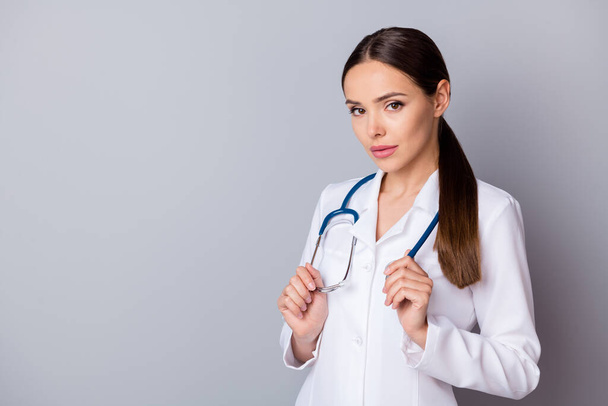 Portrait photo of attractive serious family doc experienced skilled professional listen attentively patient complaining wear medical uniform lab coat stethoscope isolated grey background - Foto, Imagen