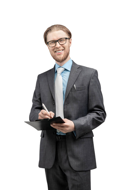 vertical portrait one man businessman or office-worker in glasses spectacles, stand with notebook and smile, on white background, isolated - Foto, Imagen