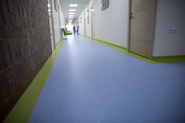 Long corridor in hospital with doors and reflections. - Фото, зображення