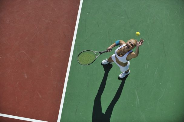 Young woman play tennis - 写真・画像