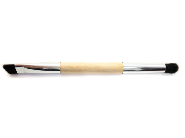 Eyebrow brush isolated on a white background. Natural wooden eyebrow brush. - Photo, Image