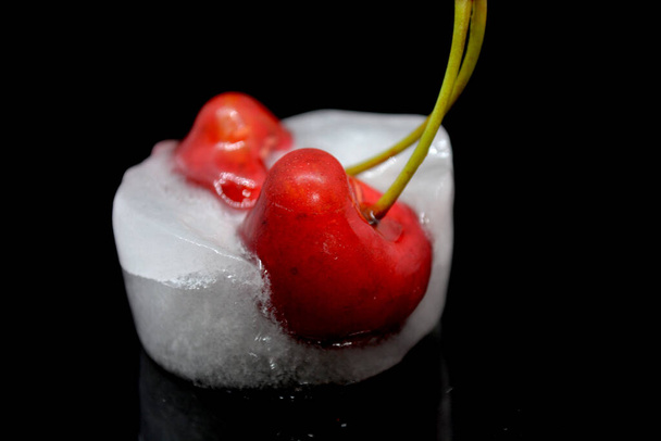 frozen cherry red fruit on black background - Photo, Image