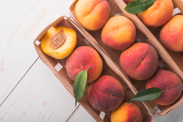 a lot of fresh peaches on a white table - Photo, Image